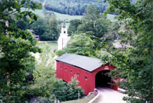 Covered bridge near homes and chruch in Vermont
